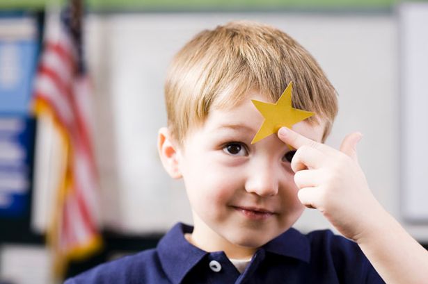 Child with gold star on head