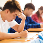 Stressed college student for exam in classroom